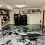 Epoxy-coated concrete floor with metallic swirls creating a modern, decorative design.