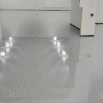 Epoxy flooring in a commercial warehouse, showing durability and seamless shine.